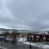 View from just outside the Arctic Cathedral, with brightly coloured buildings nearby and the city proper visible across the water.